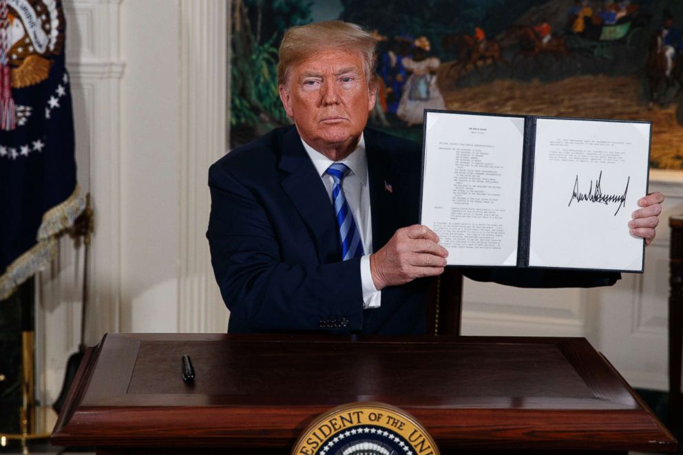 PHOTO: President Donald Trump shows a signed Presidential Memorandum after delivering a statement on the Iran nuclear deal from the Diplomatic Reception Room of the White House, May 8, 2018, in Washington.