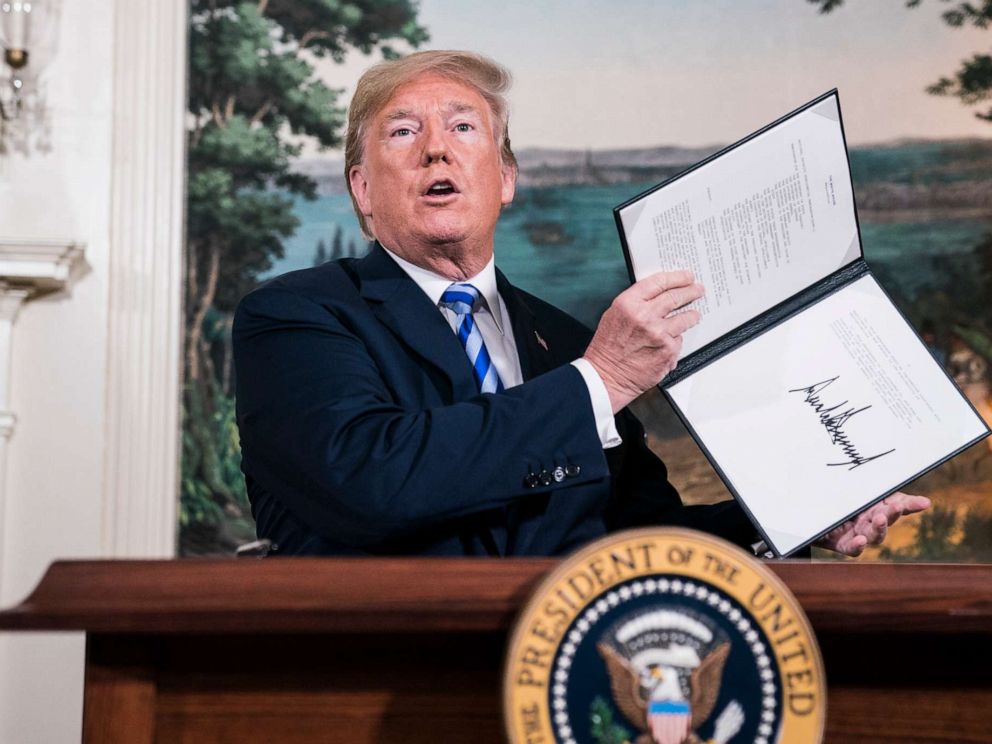 PHOTO: President Donald Trump signs a National Security Presidential Memorandum as he announces the withdrawal of the United States from the Iran nuclear deal in the Diplomatic Reception Room of the White House, May 08, 2018.