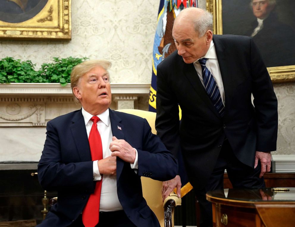 PHOTO: White House Chief of Staff John Kelly, right, leans in to talk with President Donald Trump in the Oval Office of the White House in Washington.