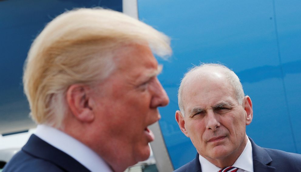 PHOTO: White House Chief of Staff John Kelly listens as President Donald Trump talks to the media beside Air Force One as the president heads to the National Rifle Association (NRA) convention in Dallas from Joint Base Andrews in Maryland, May 4, 2018. 