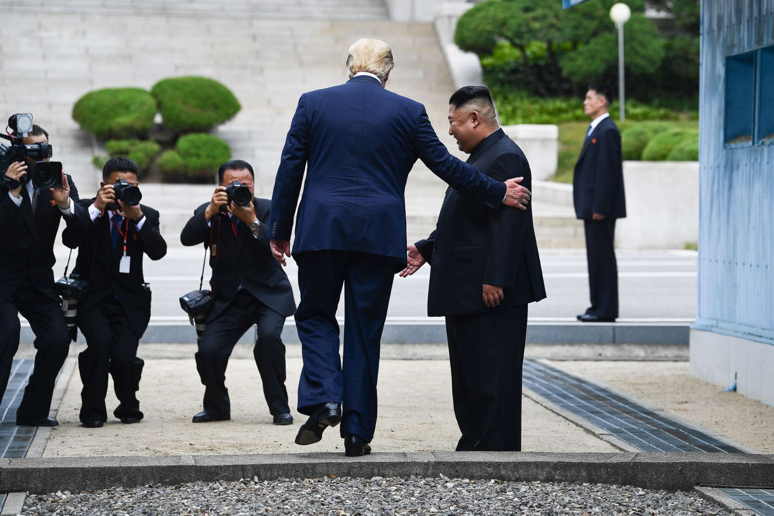 PHOTO: President Donald Trump steps into the northern side of the Military Demarcation Line that divides North and South Korea, as North Korea's leader Kim Jong Un looks on, in the Demilitarized zone (DMZ), June 30, 2019.