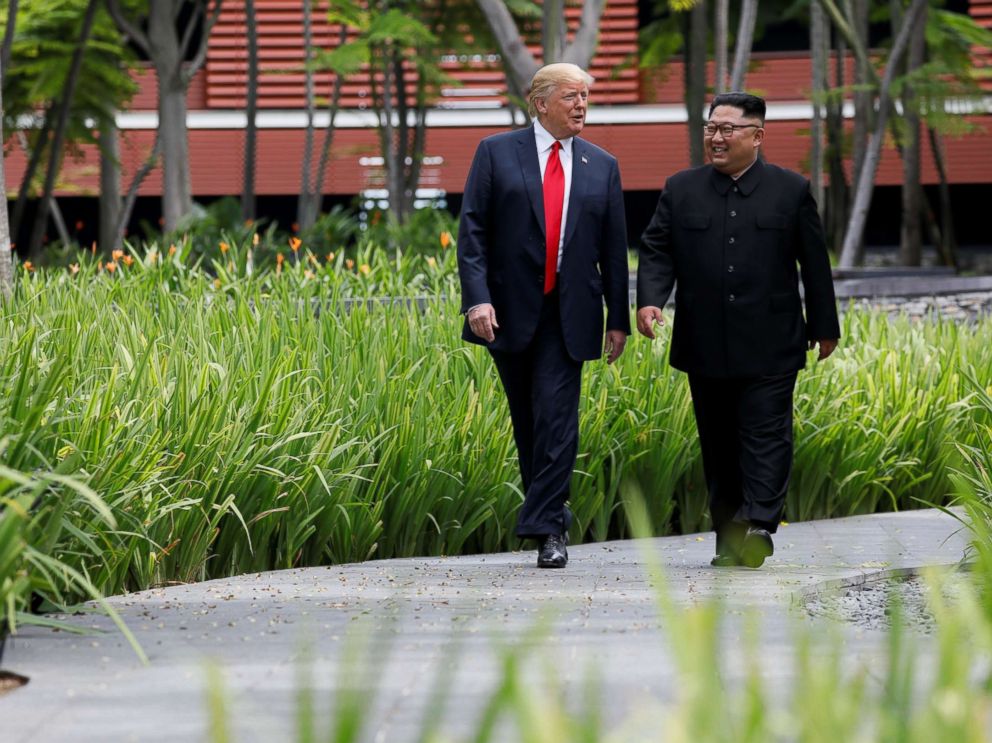 PHOTO: President Donald Trump and North Korean leader Kim Jong Un walk after lunch during their historic summit in Singapore, June 12, 2018.