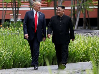 PHOTO: President Donald Trump and North Korean leader Kim Jong Un walk after lunch during their historic summit in Singapore, June 12, 2018.
