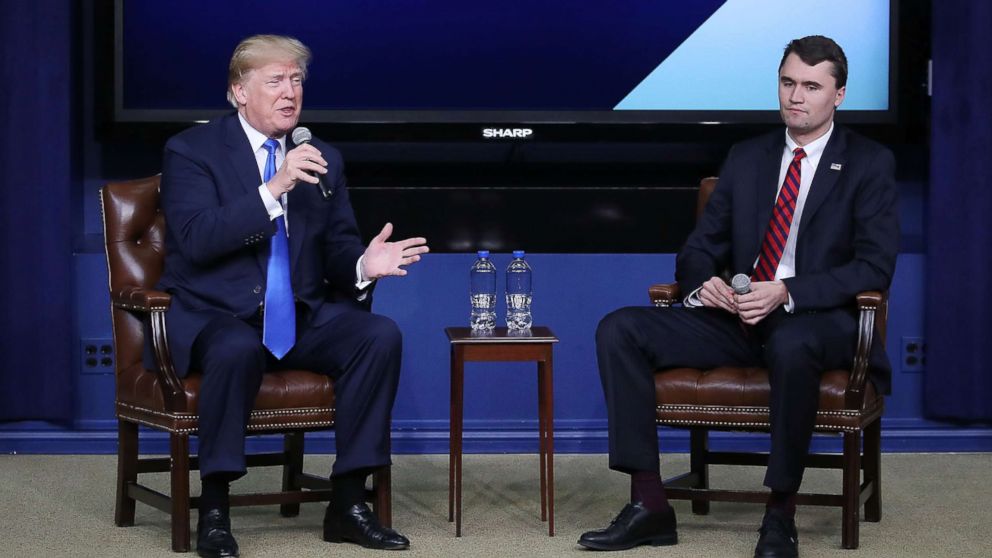 President Donald Trump (L) speaks with conservative activist Charlie Kirk at a forum dubbed the Generation Next Summit at the White House, March 22, 2018.
