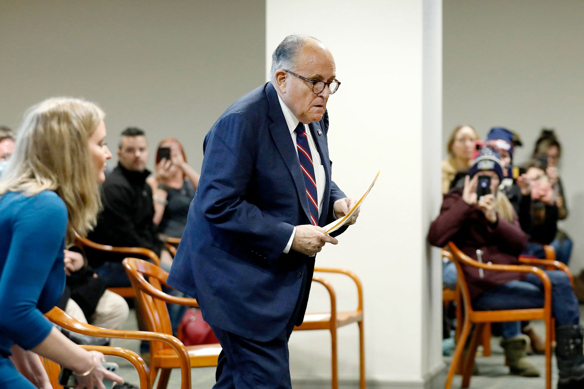 PHOTO: Rudy Giuliani, personal lawyer of President Donald Trump, walks to take his seat during an appearance before the Michigan House Oversight Committee in Lansing, Mich., Dec. 2, 2020. 