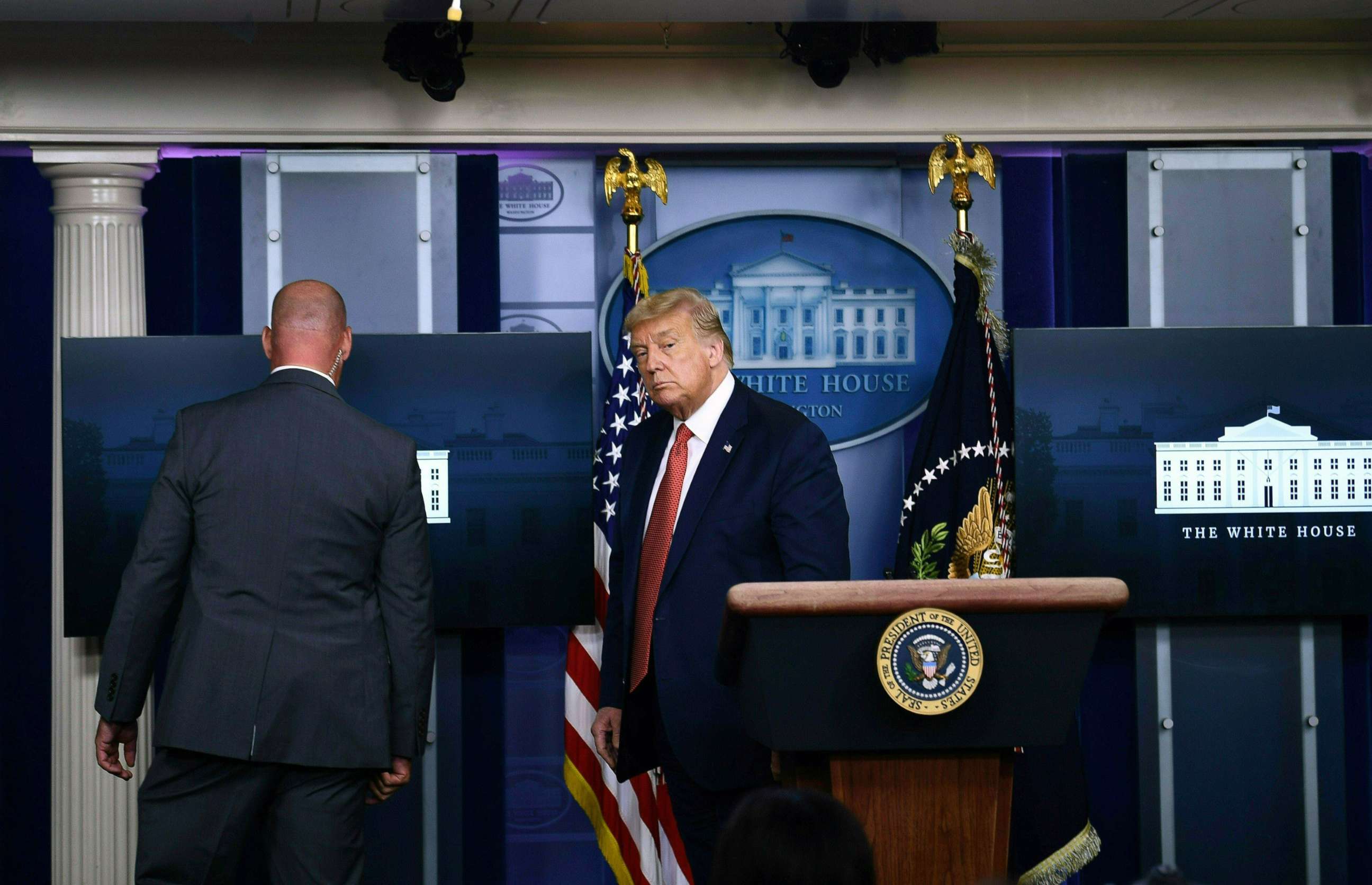 PHOTO:President Donald Trump is escorted a member of the secret service from the Brady Briefing Room of the White House, Aug. 10, 2020.