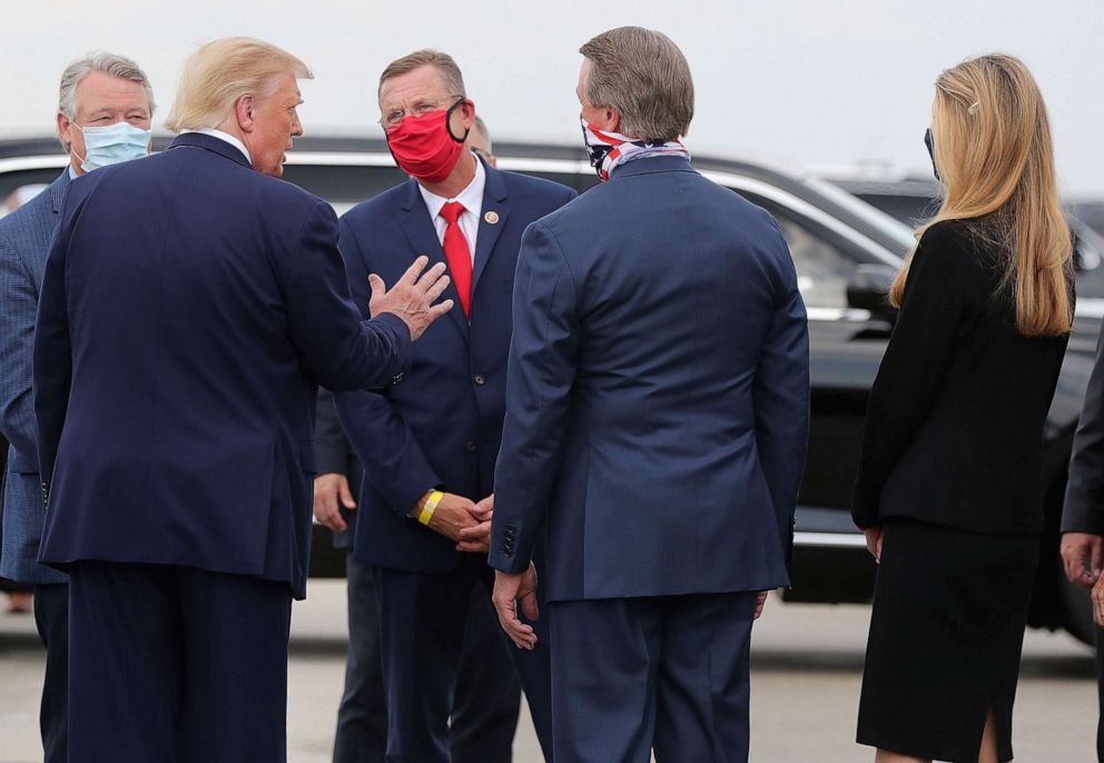 PHOTO: Congressman Rick Allen, from left, President Donald Trump, Congressman Doug Collins, Senator David Perdue, and Senator Kelly Loeffler greet each other at the Hartsfield-Jackson International Airport on July 15, 2020, in Atlanta.