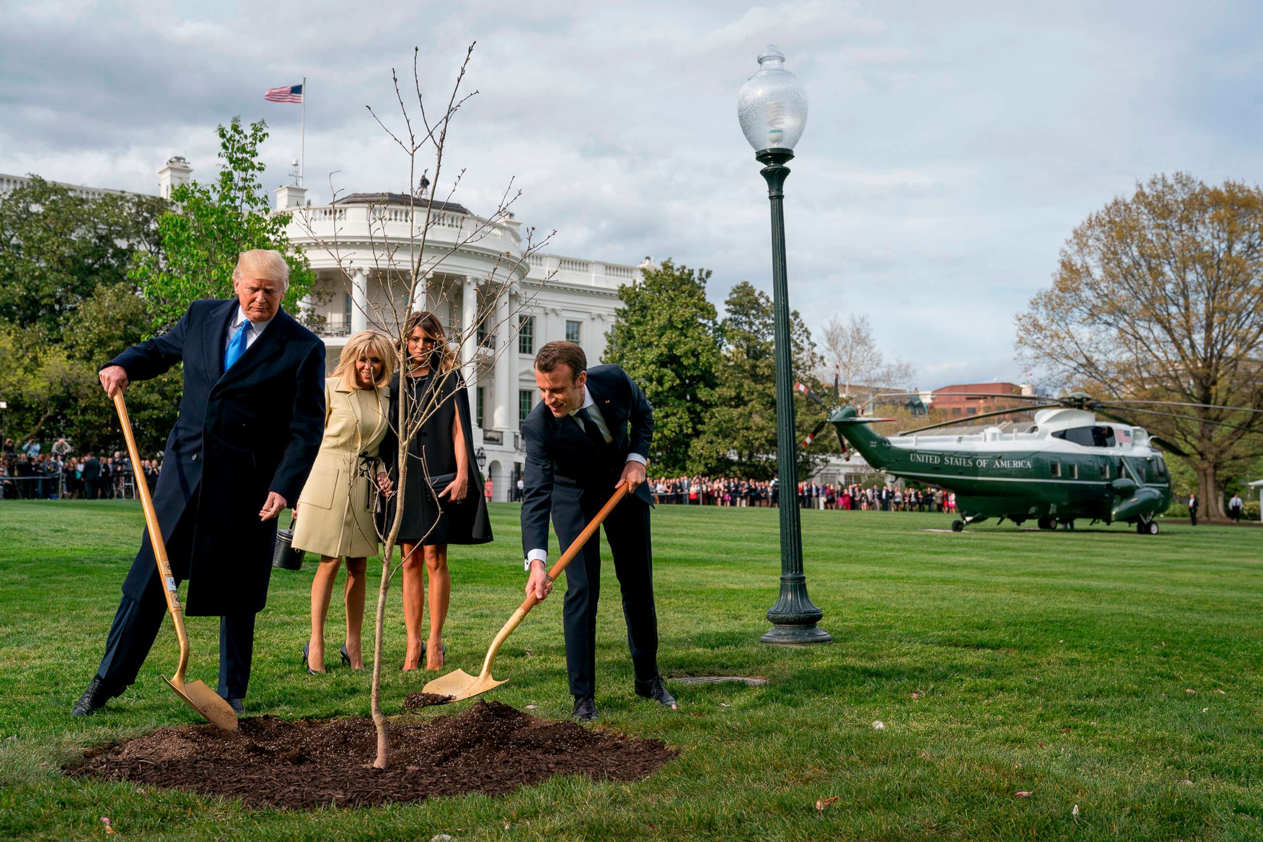 PHOTO: In this April 23, 2018, file photo, President Donald Trump and French President Emmanuel Macron participate in a tree planting ceremony on the South Lawn of the White House in Washington. 