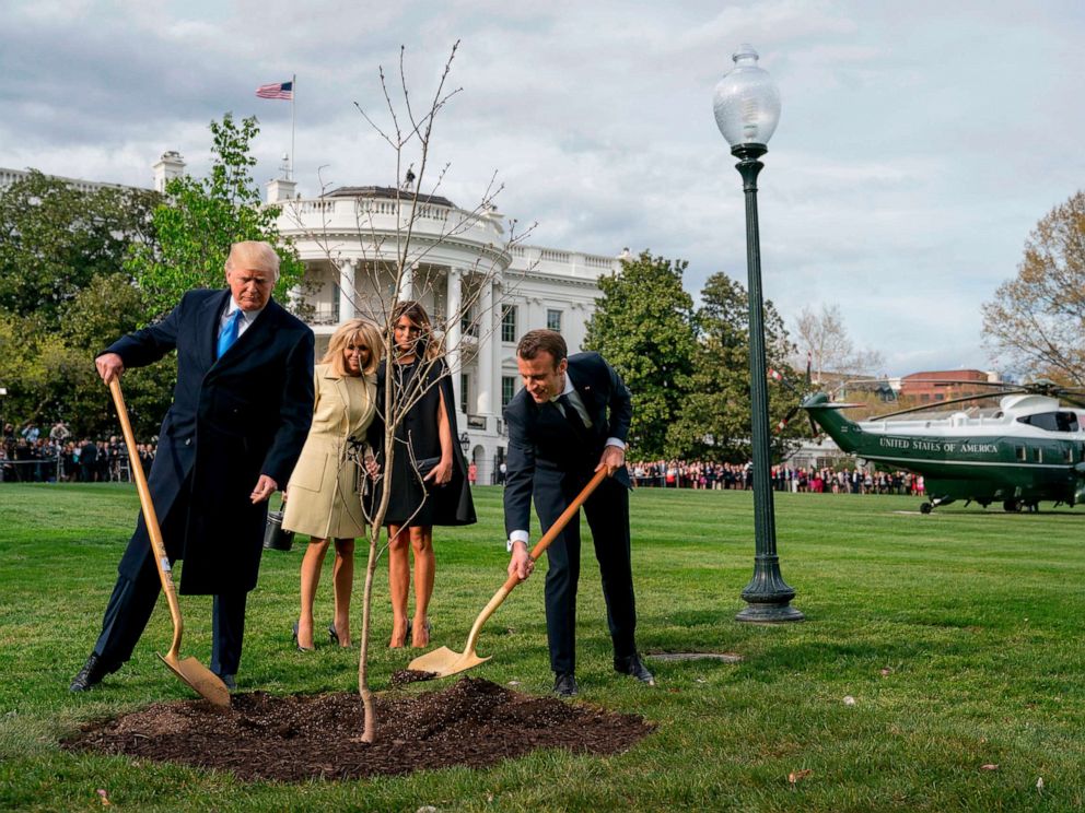 PHOTO: In this April 23, 2018, file photo, President Donald Trump and French President Emmanuel Macron participate in a tree planting ceremony on the South Lawn of the White House in Washington.