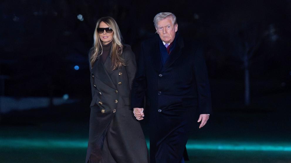 PHOTO: President Donald Trump holds hands with first lady Melania Trump as they walk on the South Lawn upon his arrival at the White House, Sunday, Nov. 30, 2025, in Washington.
