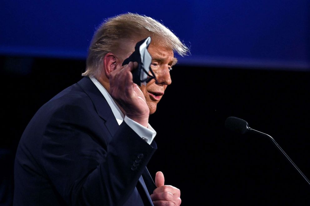 PHOTO: President Donald Trump holds a face mask as he speaks during the first presidential debate in Cleveland, Sept. 29, 2020.