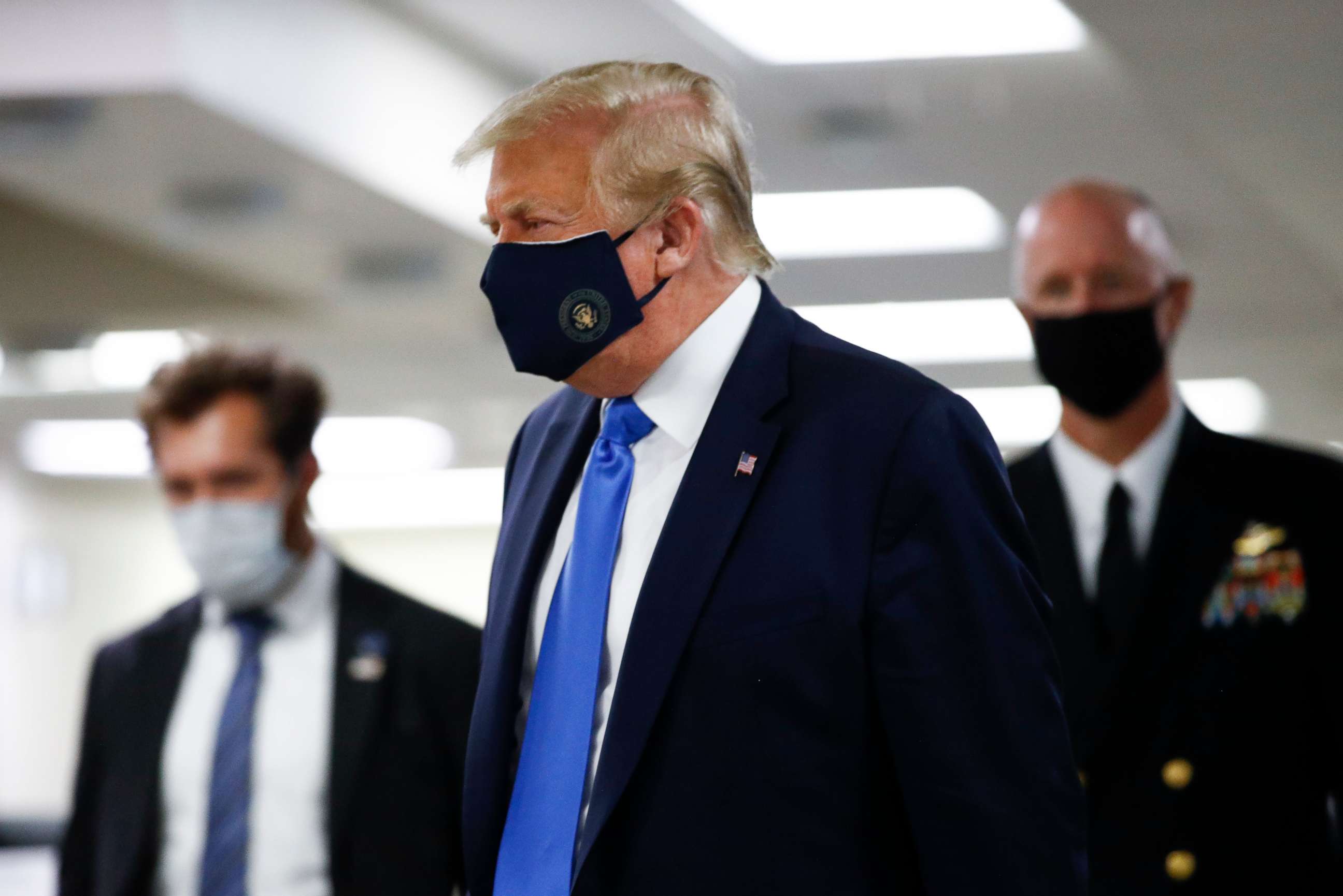 PHOTO: President Donald Trump wears a mask as he walks down the hallway during his visit to Walter Reed National Military Medical Center in Bethesda, Md., Saturday, July 11, 2020.