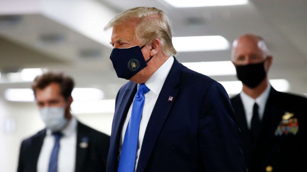 PHOTO: President Donald Trump wears a mask as he walks down the hallway during his visit to Walter Reed National Military Medical Center in Bethesda, Md., Saturday, July 11, 2020.