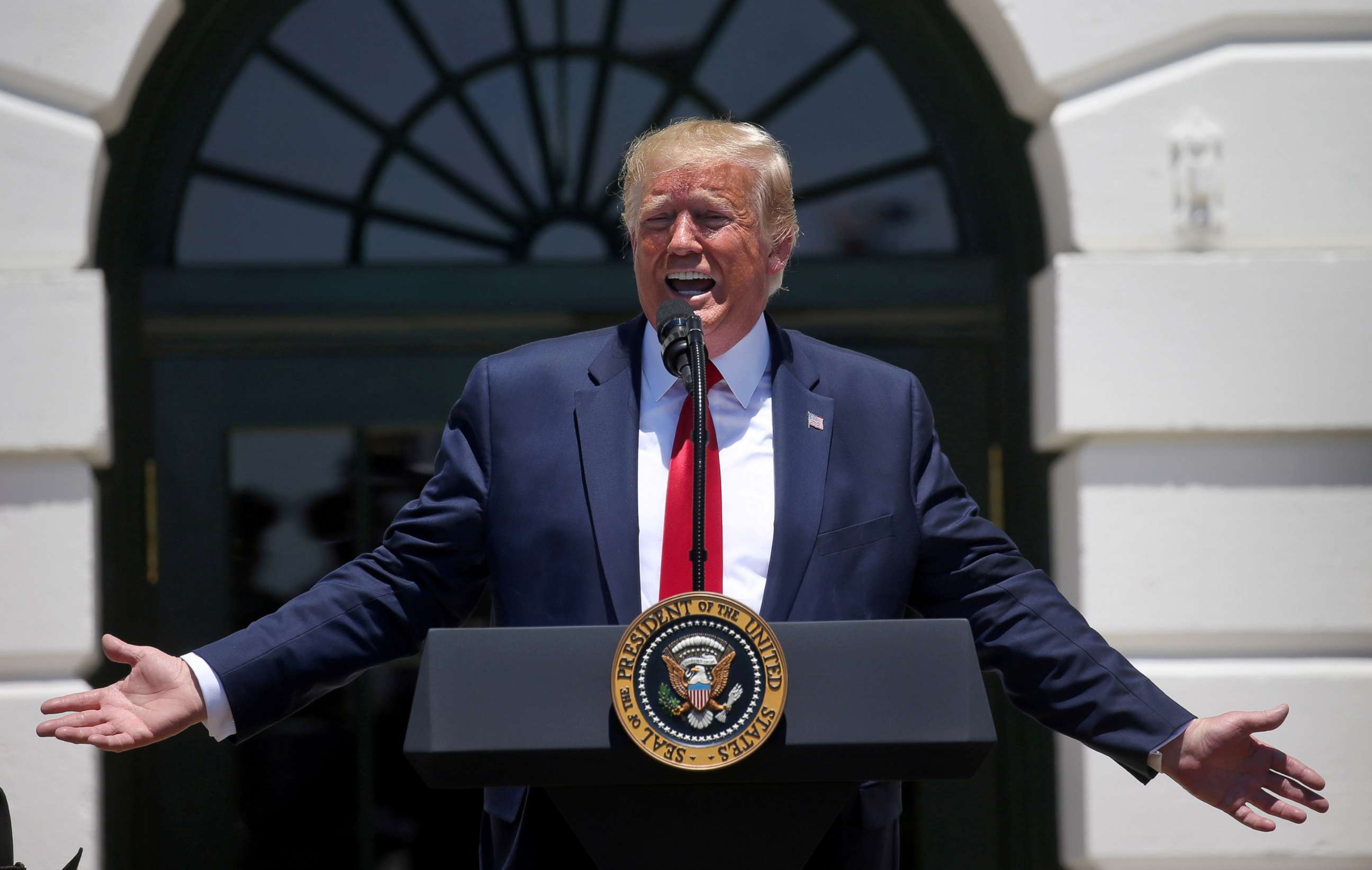 PHOTO: President Donald Trump answers questions from the media during an event on the South Lawn of the White House, July 15, 2019.