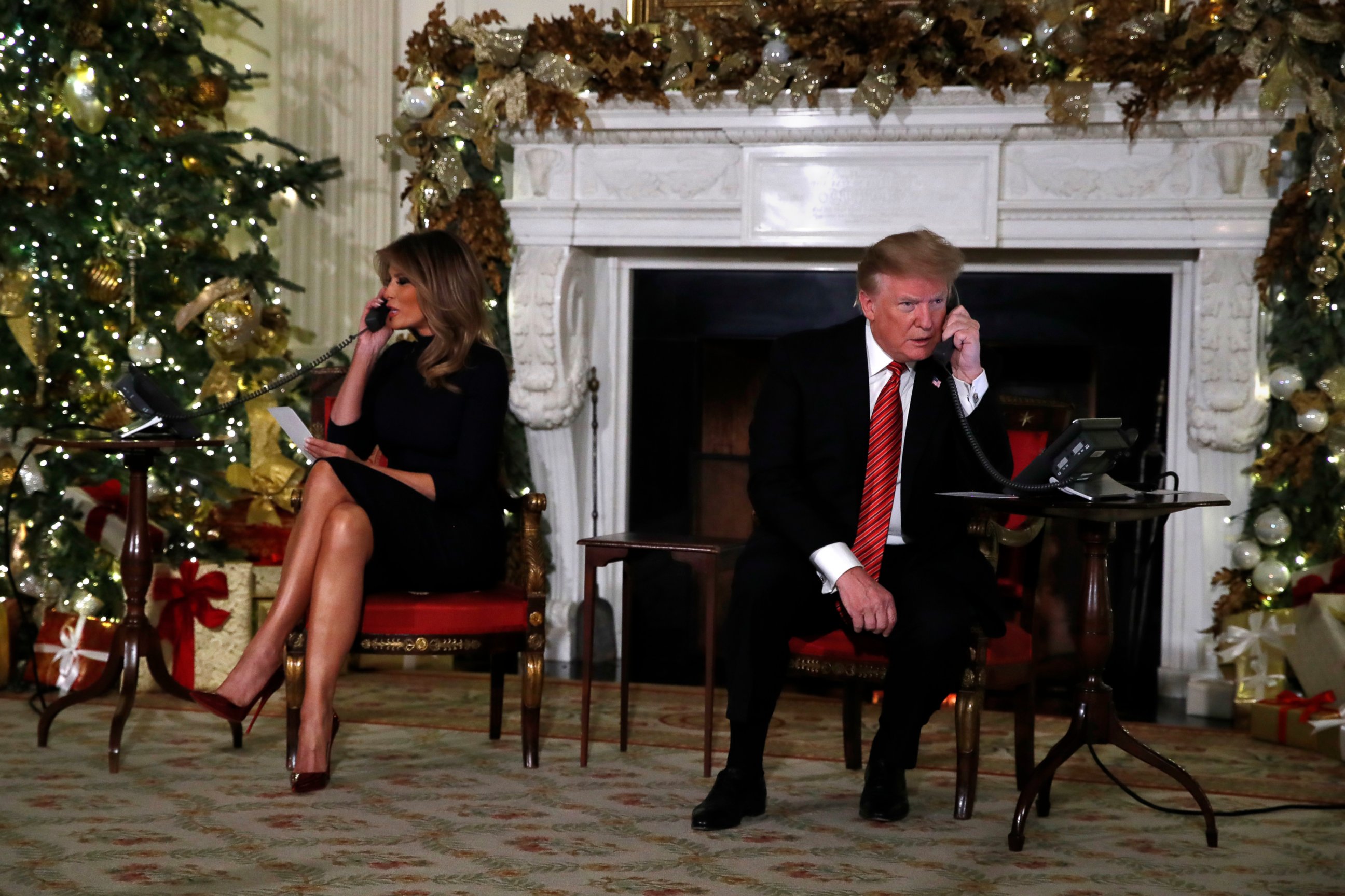 PHOTO: President Donald Trump and first lady Melania Trump each speak on the phone sharing updates to track Santa's movements from the North American Aerospace Defense Command (NORAD) Santa Tracker on Christmas Eve, Monday, Dec. 24, 2018. 