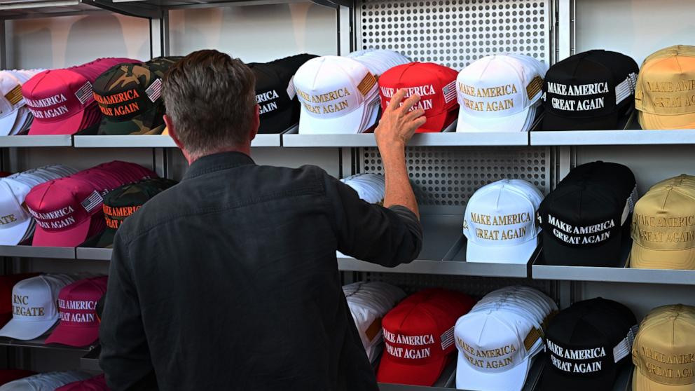 PHOTO: A person looks at political merchandise for sale on the first day of the Republican National Convention at the Fiserv Forum, July 15, 2024, in Milwaukee.