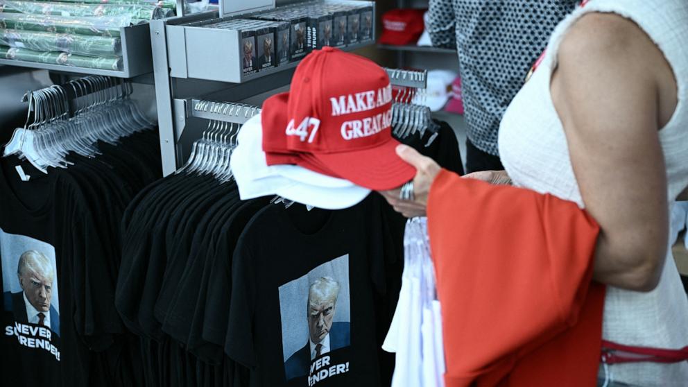 PHOTO: People buy merchandise supporting former U.S. President and Republican presidential candidate Donald Trump during the first day of the 2024 Republican National Convention at the Fiserv Forum, July 15, 2024, in Milwaukee.