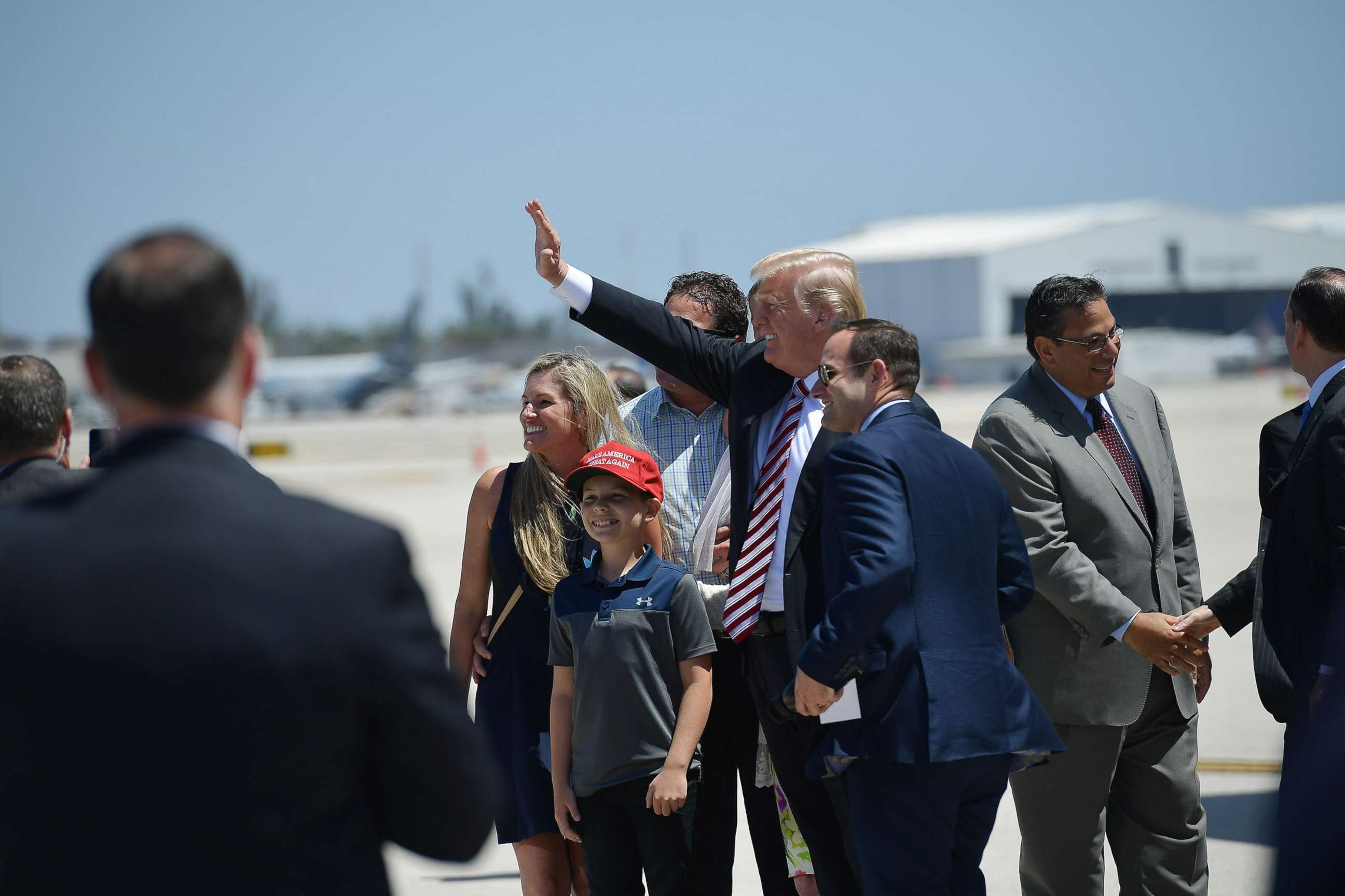 PHOTO: President Donald Trump waves as he steps off Air Force One upon arrival at Miami International Airport in Miami on April 16, 2018.