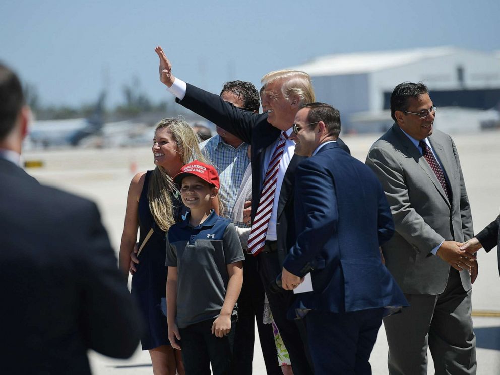 PHOTO: President Donald Trump waves as he steps off Air Force One upon arrival at Miami International Airport in Miami on April 16, 2018.