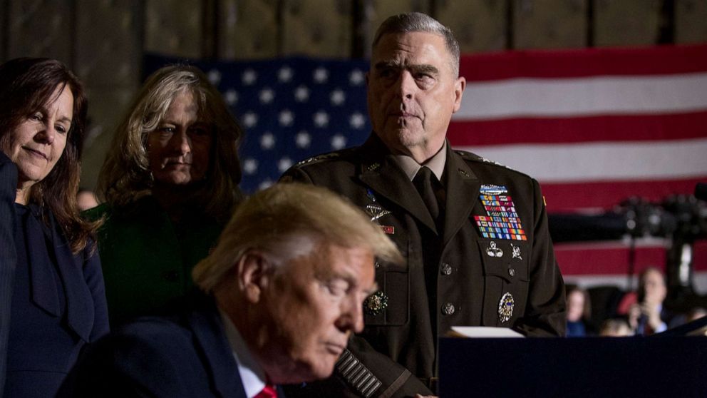 PHOTO: Joint Chiefs Chairman Gen. Mark Milley, top center, watches as President Donald Trump signs the National Defense Authorization Act for Fiscal Year 2020 at Andrews Air Force Base, Md., Dec. 20, 2019.