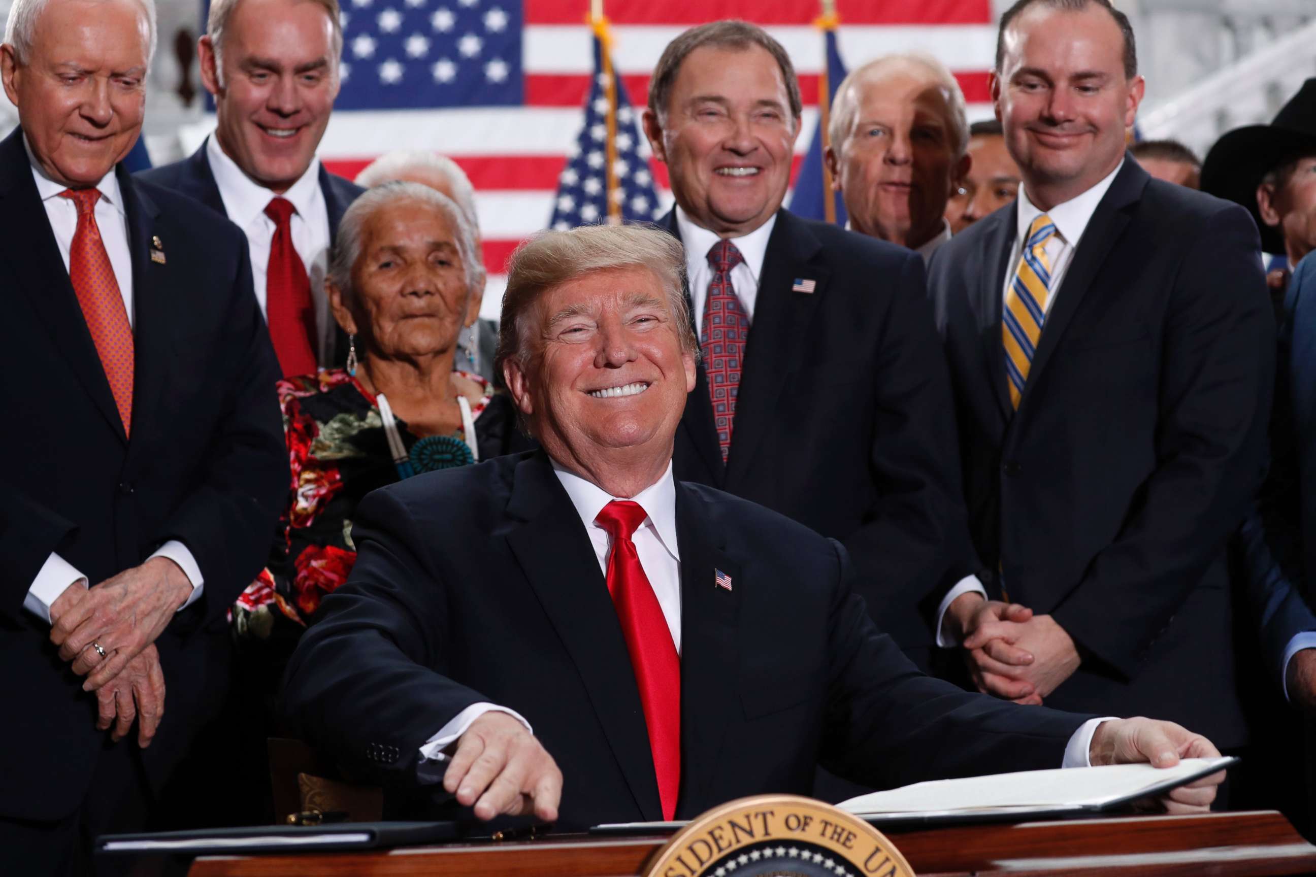 PHOTO: President Donald Trump smiles upon signing an executive order after announcing big cuts to Utah's sprawling wilderness national monuments at the Utah State Capitol in Salt Lake City, Dec. 4, 2017. 