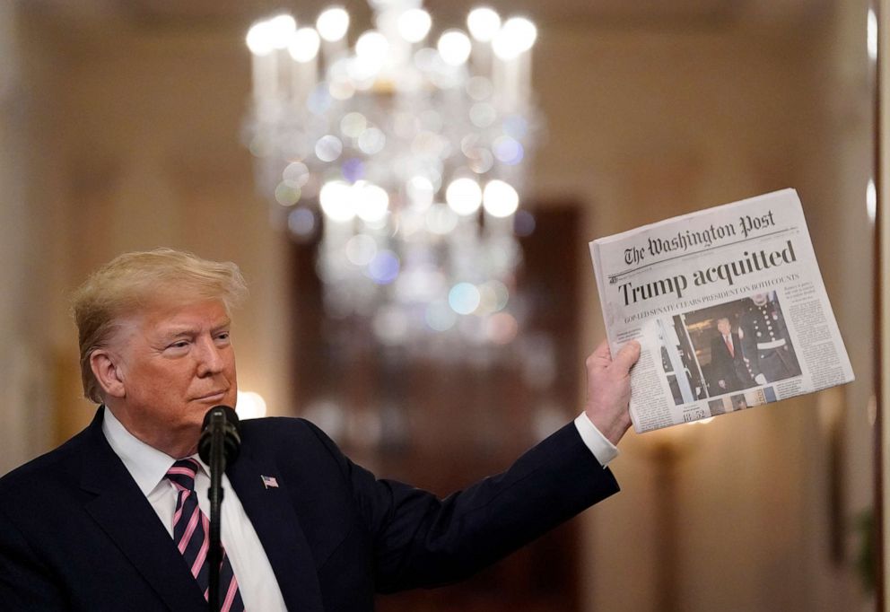 PHOTO: President Donald Trump holds a copy of The Washington Post as he speaks in the East Room of the White House one day after the Senate acquitted him on two articles of impeachment, Feb. 6, 2020, in Washington, DC.