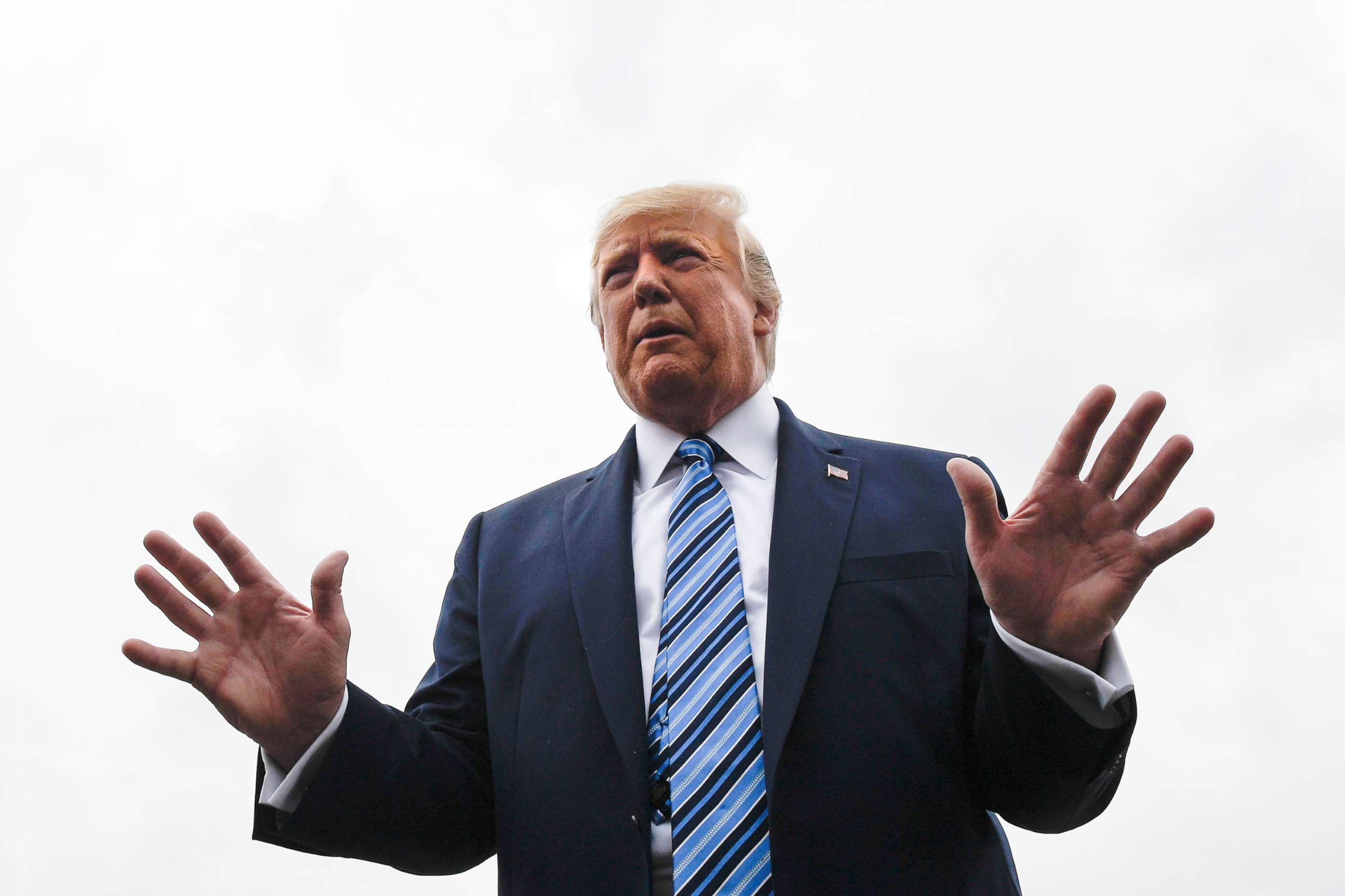 PHOTO: President Donald Trump talks to reporters at Morristown Municipal Airport in Morristown, N.J., Aug. 13, 2019.