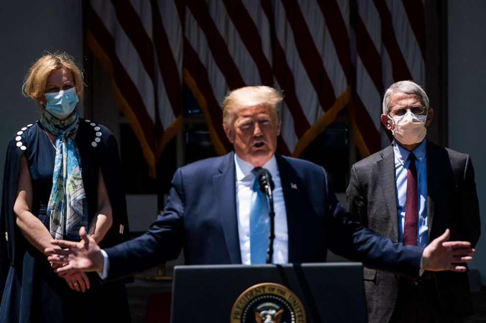 PHOTO: White House coronavirus response coordinator Dr. Deborah Birx, left, and Director of the National Institute of Allergy and Infectious Diseases Dr. Anthony Fauci, both wearing face masks listen at the White House on Friday, May 15, 2020.