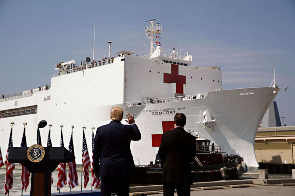 PHOTO: In this March 28, 2020, file photo, President Donald Trump waves as the USNS Comfort pulls away from the pier at Naval Station Norfolk in Norfolk, Va.