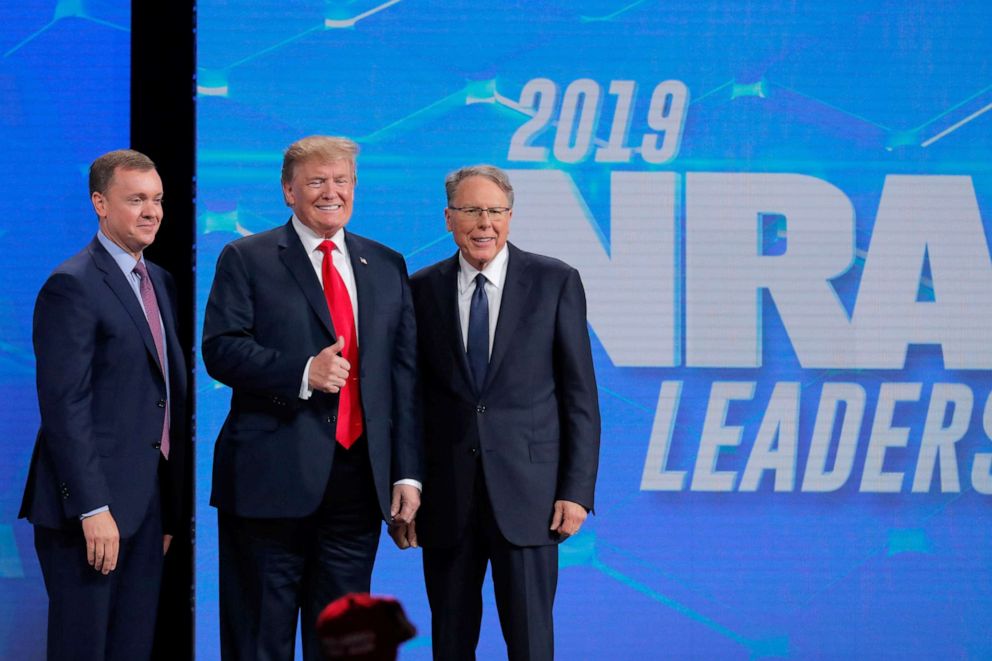 PHOTO: President Donald Trump is greeted by Chris Cox, left, and Wayne LaPierre, right, executive vice president and CEO of the National Rifle Association (NRA) at the NRA annual meeting in Indianapolis, Indiana, April 26, 2019.