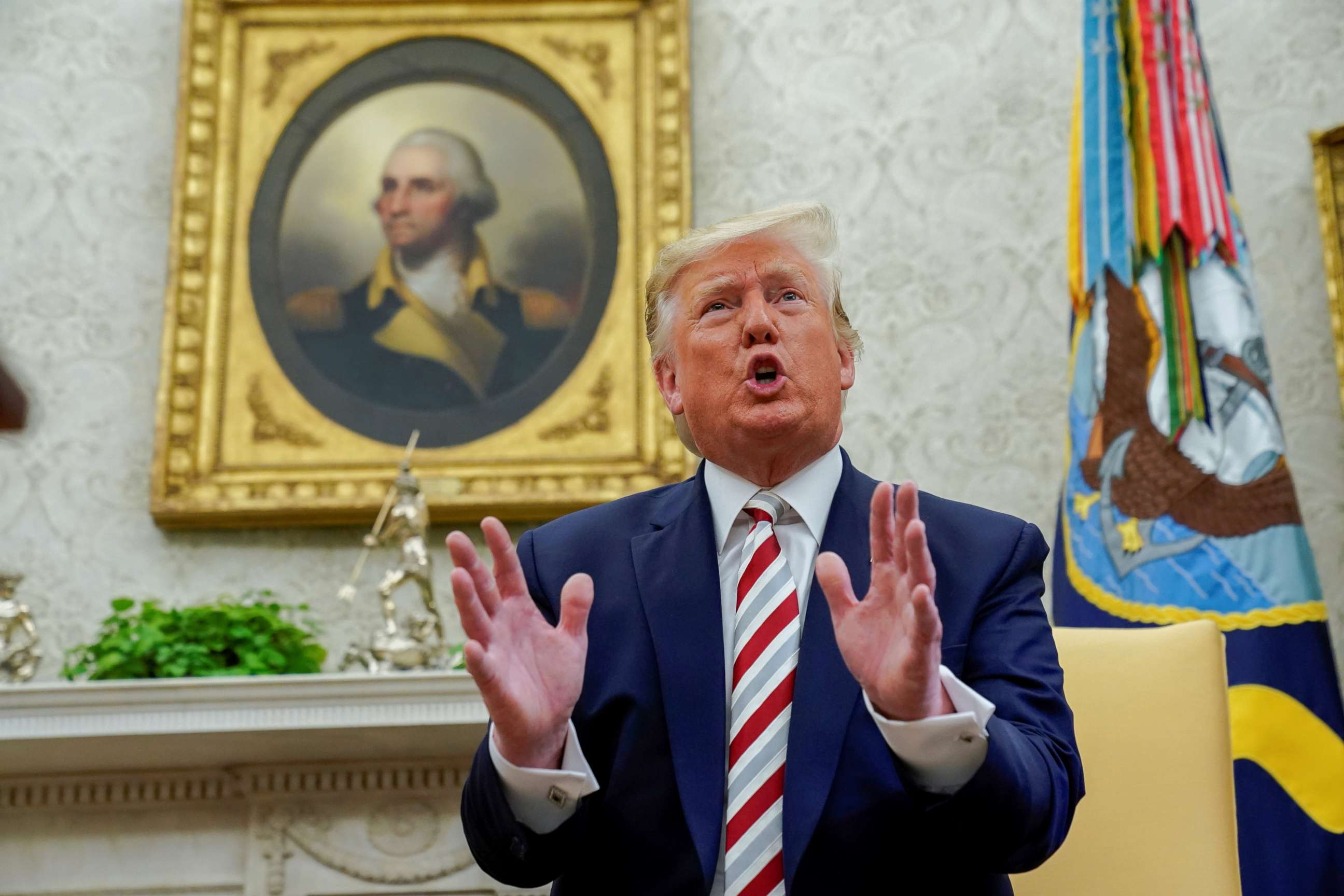 PHOTO: U.S. President Donald Trump answers questions from reporters as he meets with Romania's President Klaus Iohannis in the Oval Office of the White House in Washington, U.S. August 20, 2019.