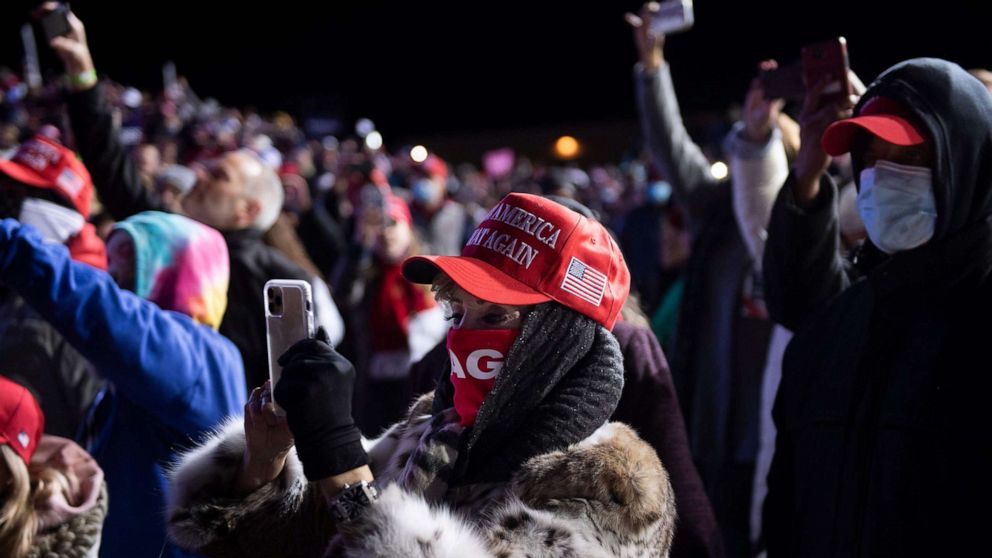 PHOTO: People cheer as President Donald Trump arrives on a cold night for a "Make America Great Again" rally at Eppley Airfield on Oct. 27, 2020, in Omaha, Nebraska.