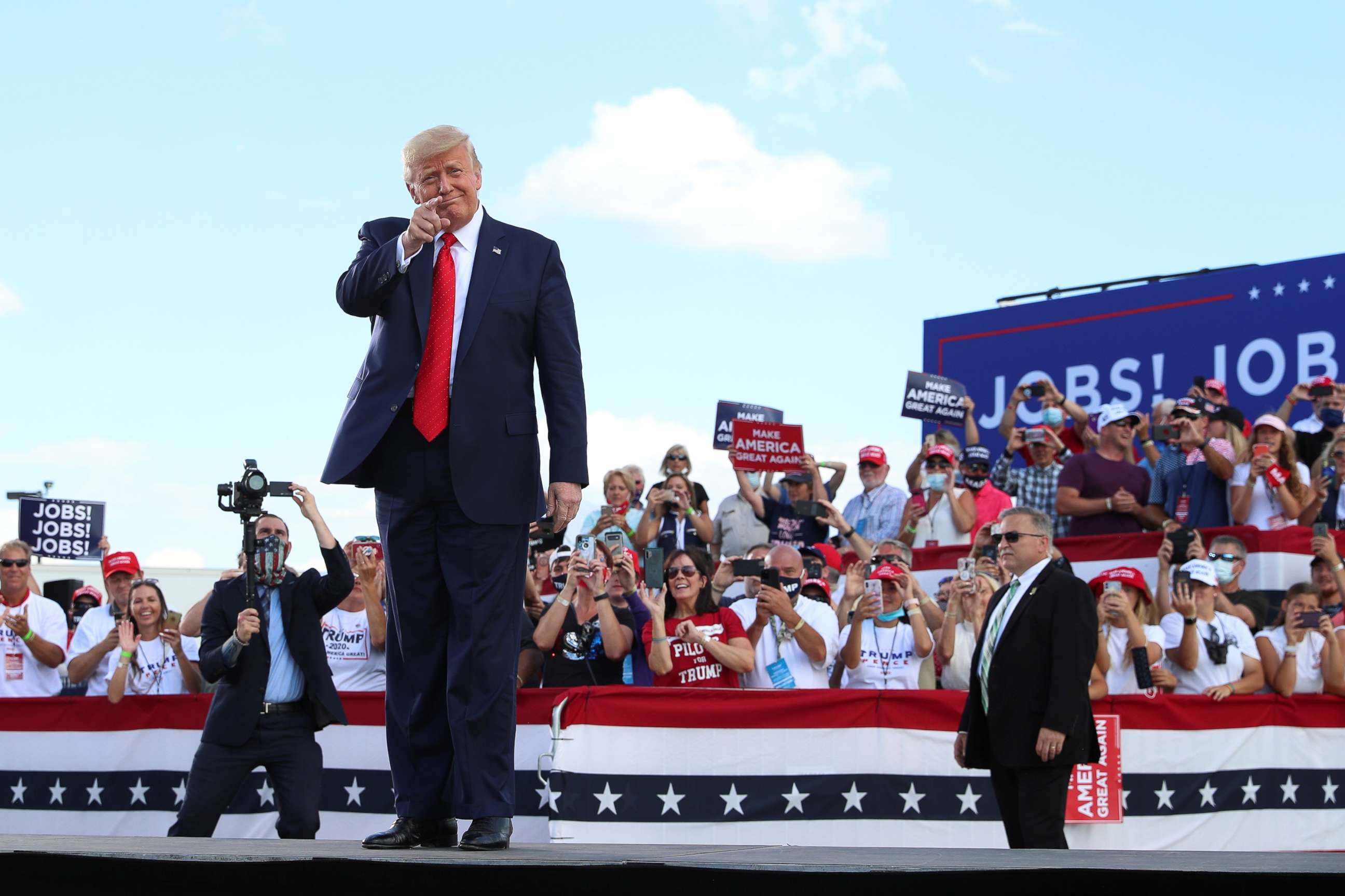 PHOTO: President Donald Trump gestures in front of supporters at Basler Flight Service in Oshkosh, Wis., Aug. 17, 2020.