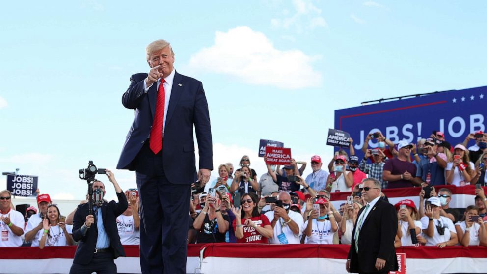 PHOTO: President Donald Trump gestures in front of supporters at Basler Flight Service in Oshkosh, Wis., Aug. 17, 2020.