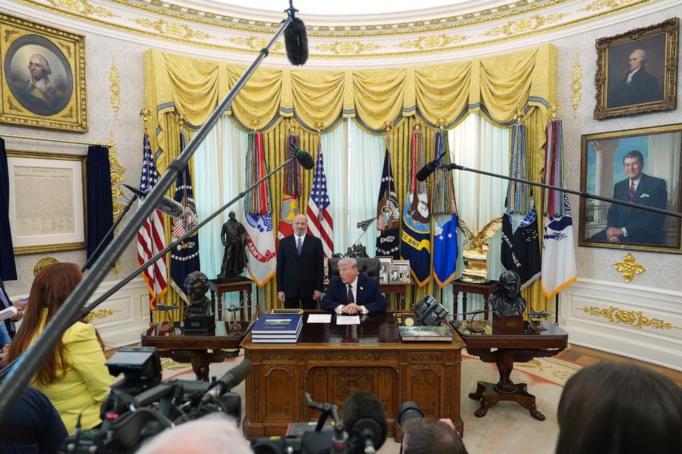 PHOTO: President Donald Trump answers questions from reporters after signing an executive order in the Oval Office of the White House in Washington, March 31, 2026.