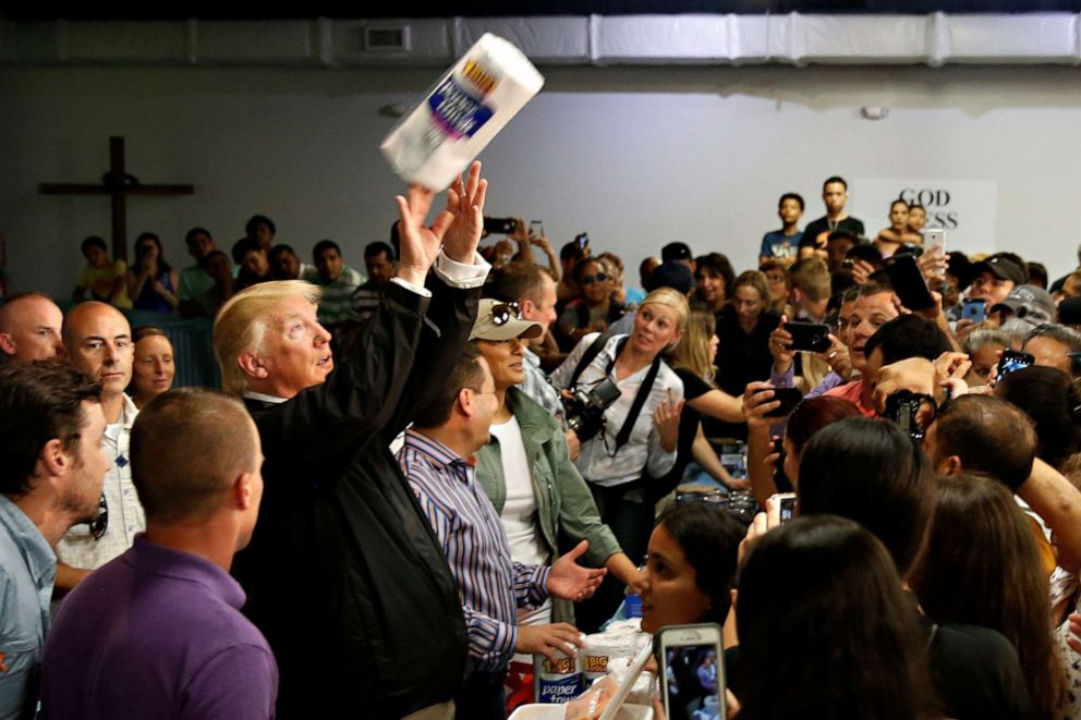 PHOTO: President Donald Trump tosses rolls of paper towels to people at a hurricane relief distribution center at Calvary Chapel in San Juan, Puerto Rico, Oct. 3, 2017.
