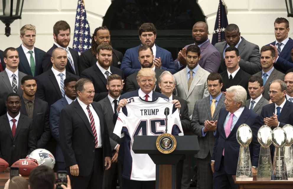 PHOTO: President Donald Trump, center, displays a jersey while standing with Bill Belichick, coach of the New England Patriots, left, and Robert Kraft, owner of the New England Patriots LP, right, at the White House in Washington, D.C., April 19, 2017.