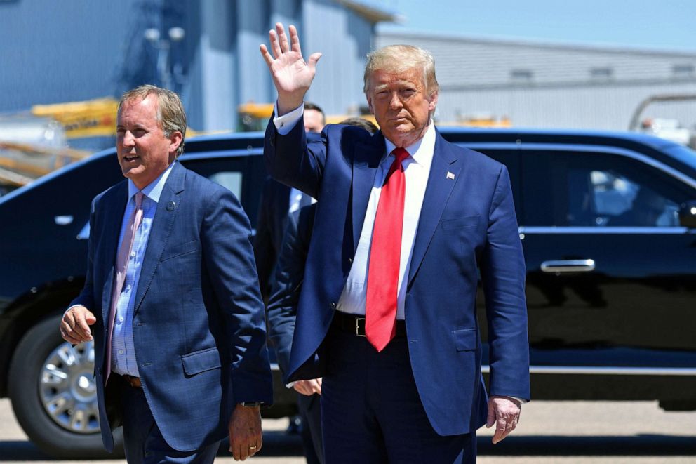 PHOTO: President Donald Trump waves upon arrival, alongside Texas Attorney General Ken Paxton in Dallas, June 11, 2020.