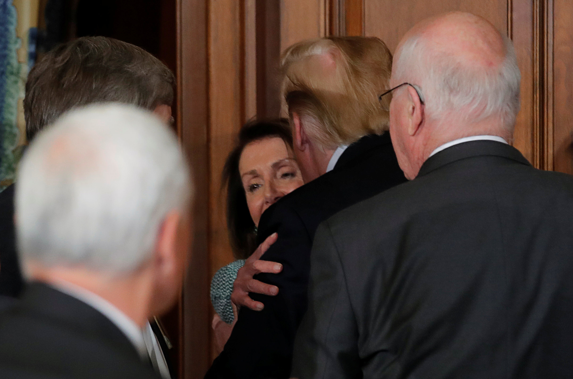 PHOTO: Speaker of the House Nancy Pelosi is hugged and kissed by President Donald Trump at the 37th annual Friends of Ireland luncheon at the U.S. Capitol in Washington, March 14, 2019.