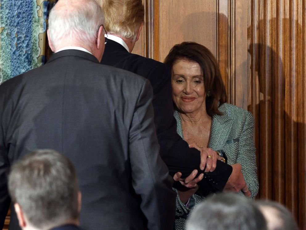 PHOTO: Speaker of the House of Representatives Nancy Pelosi seizes President Donald Trumps by the arm during the passage of the two at the Friends of Ireland luncheon on March 14, 2019 in Washington.