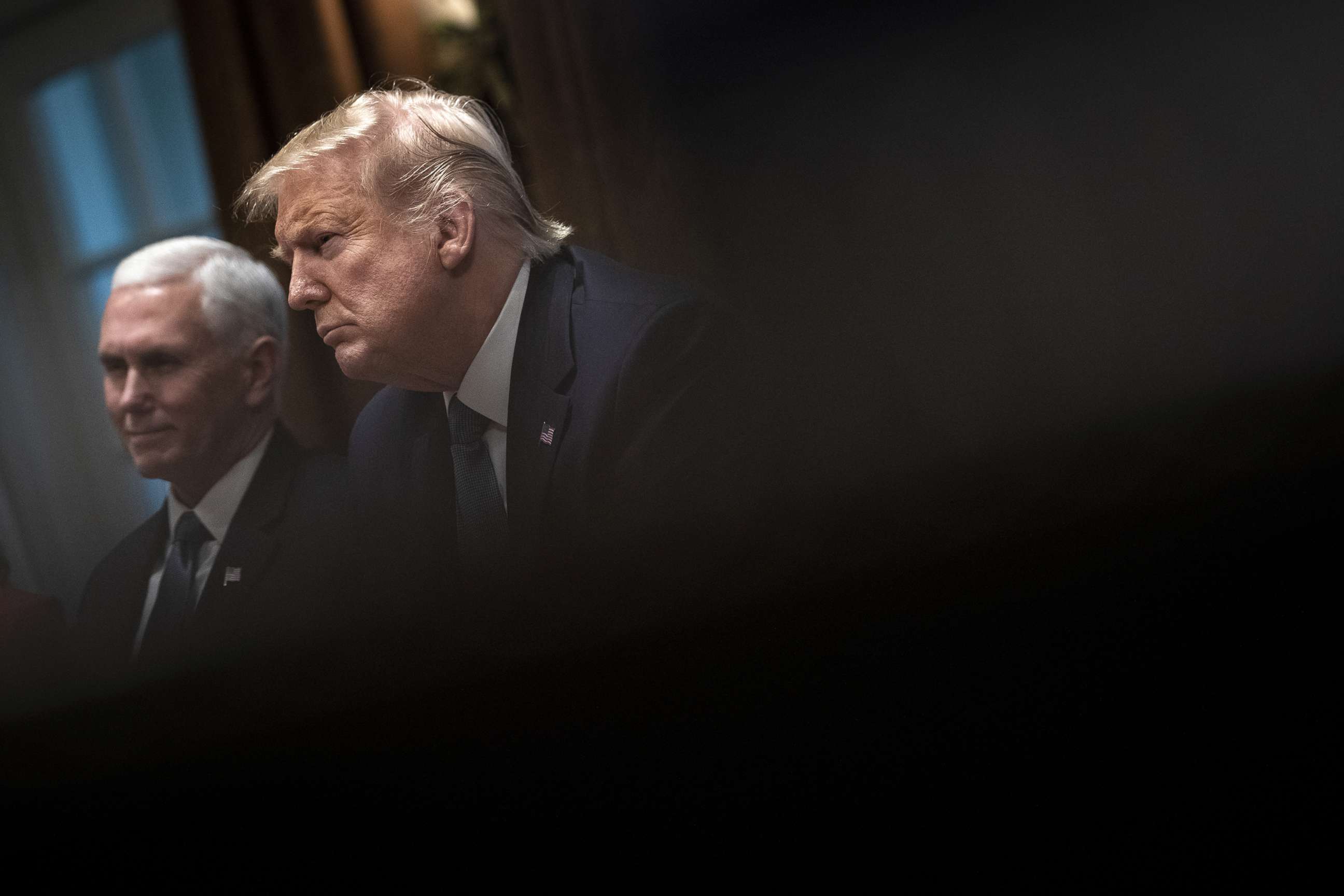 PHOTO: Vice President Mike Pence and President Donald Trump listen during a meeting about the Governors Initiative on Regulatory Innovation in the Cabinet Room of the White House on Dec. 16, 2019 in Washington, D.C.