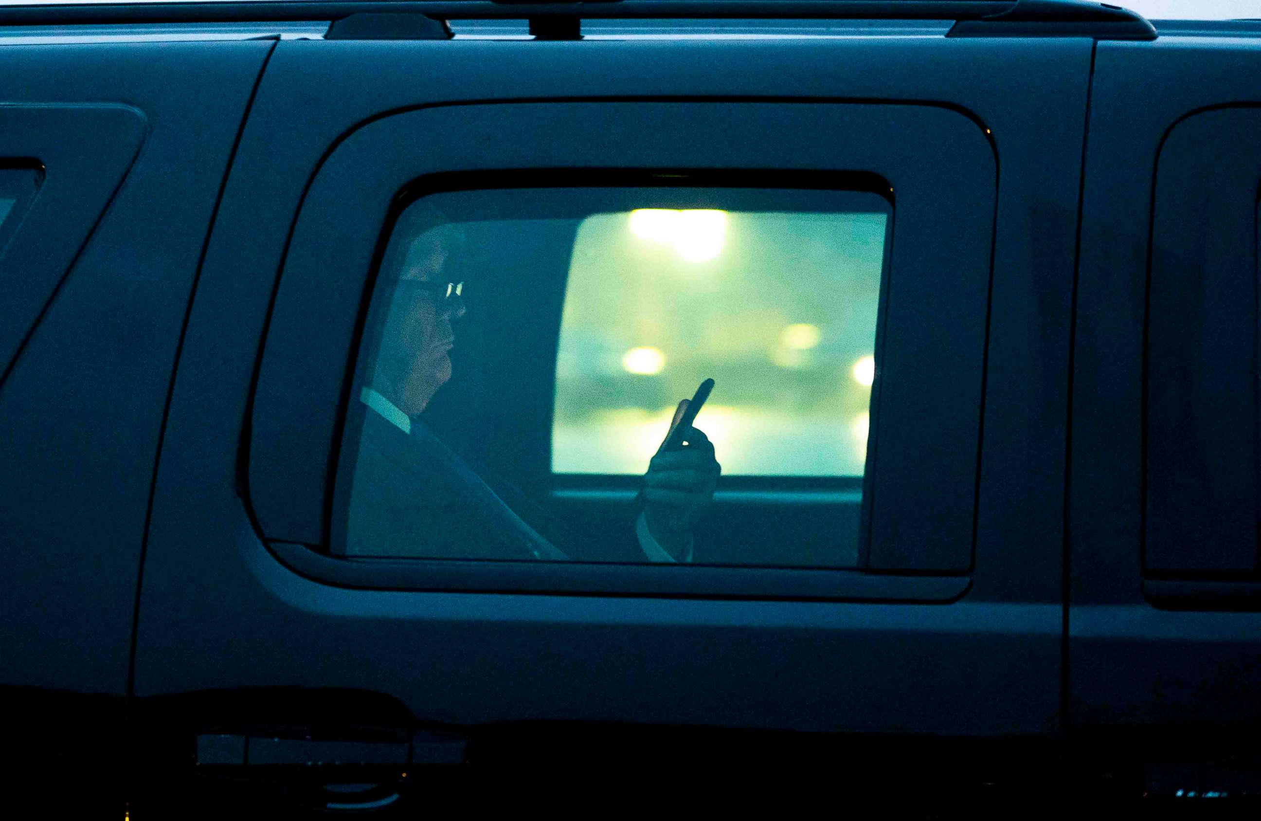 PHOTO: President Donald Trump, with reading glasses, looks at his cellphone as he departs the White House for a campaign trip to Milwaukee, Jan. 14, 2020. 