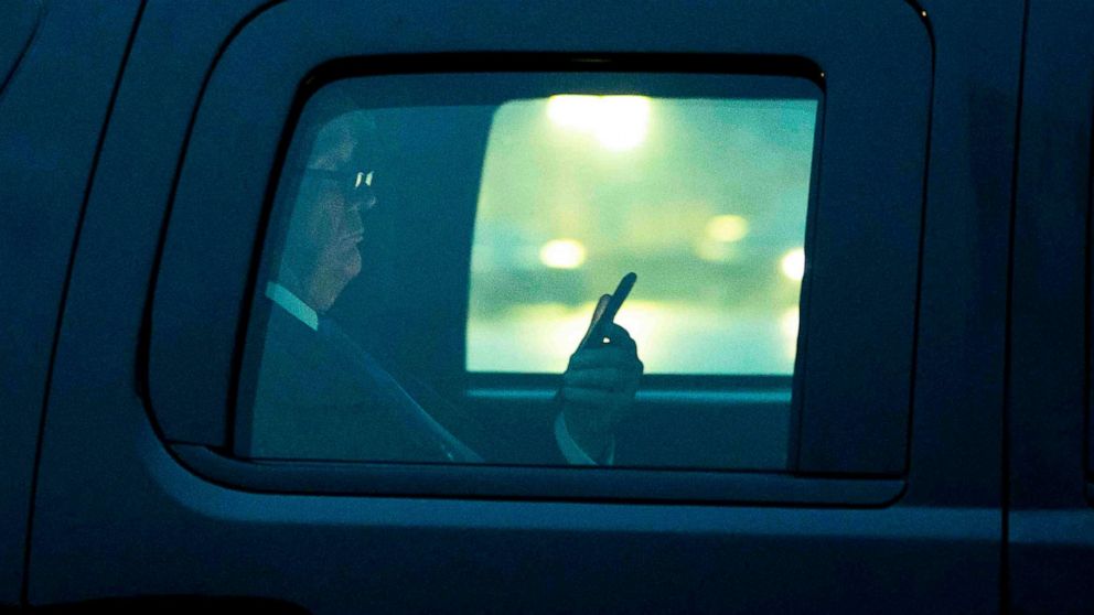 PHOTO: President Donald Trump, with reading glasses, looks at his cellphone as he departs the White House for a campaign trip to Milwaukee, Jan. 14, 2020. 