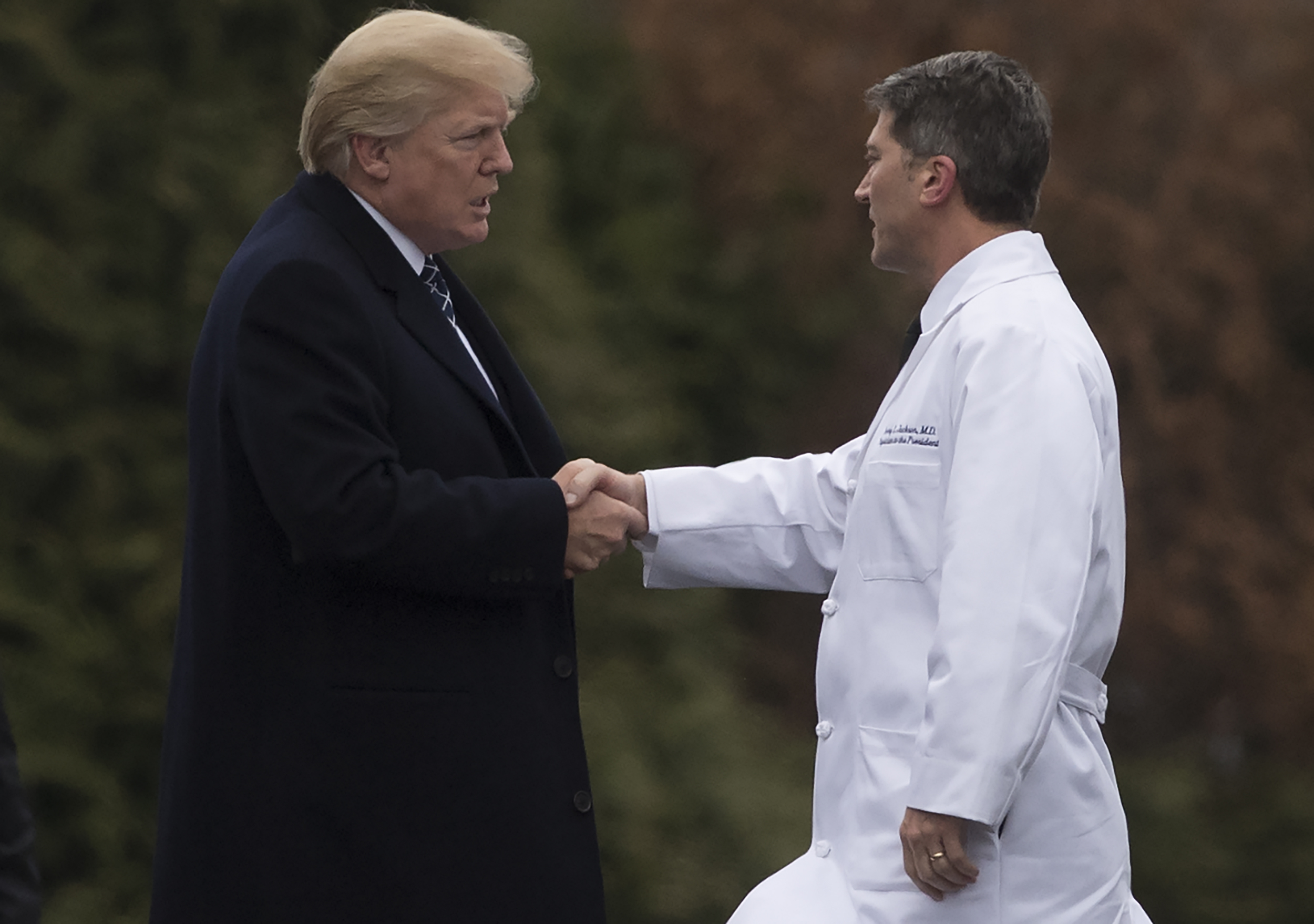 PHOTO: President Donald Trump shakes hands with White House Physician Rear Admiral Dr. Ronny Jackson, following his annual physical at Walter Reed National Military Medical Center in Bethesda, Maryland, Jan. 12, 2018. 