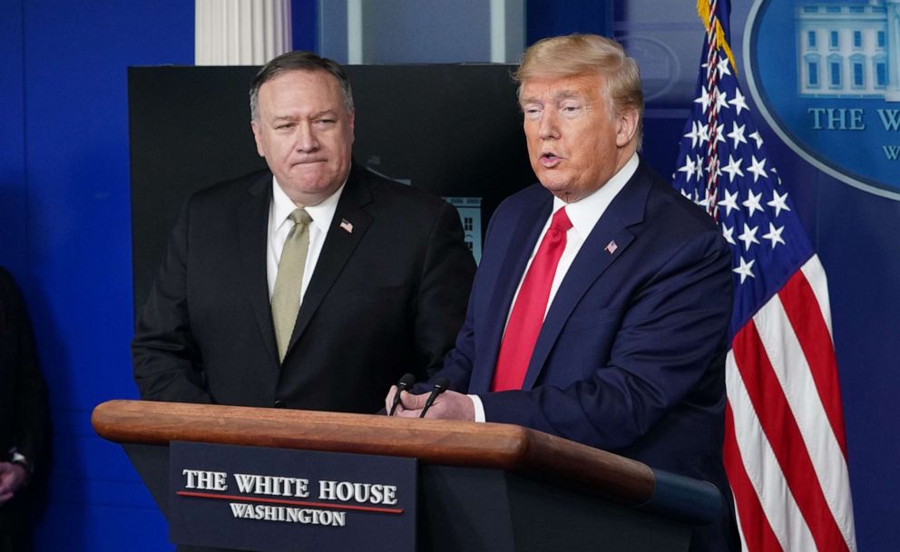 PHOTO: In this April 8, 2020, file photo, Secretary of States Mike Pompeo watches President Donald Trump speak during the daily briefing on COVID-19, in the Brady Briefing Room at the White House in Washington, DC.