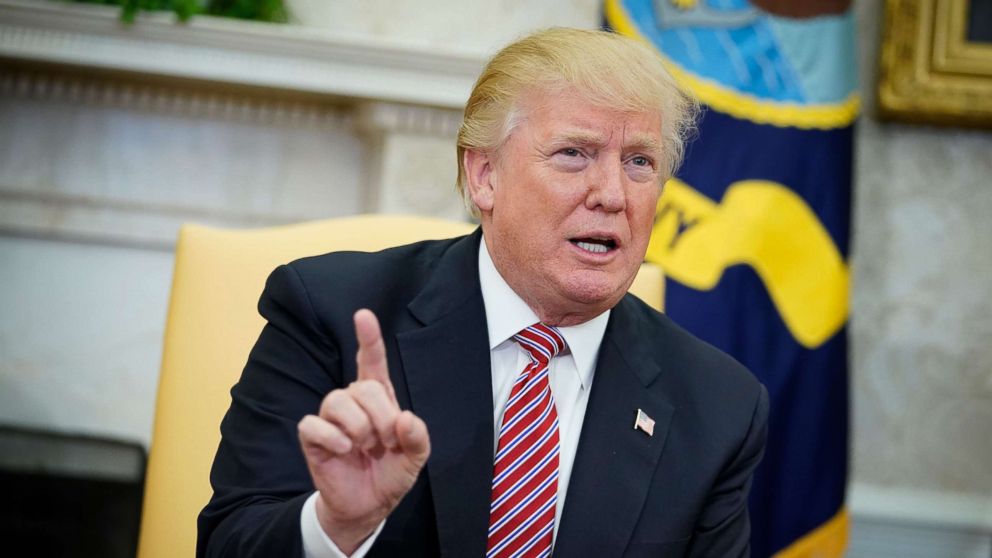 President Donald Trump responds to a reporter's question on domestic violence in the Oval Office, Feb. 14, 2018.