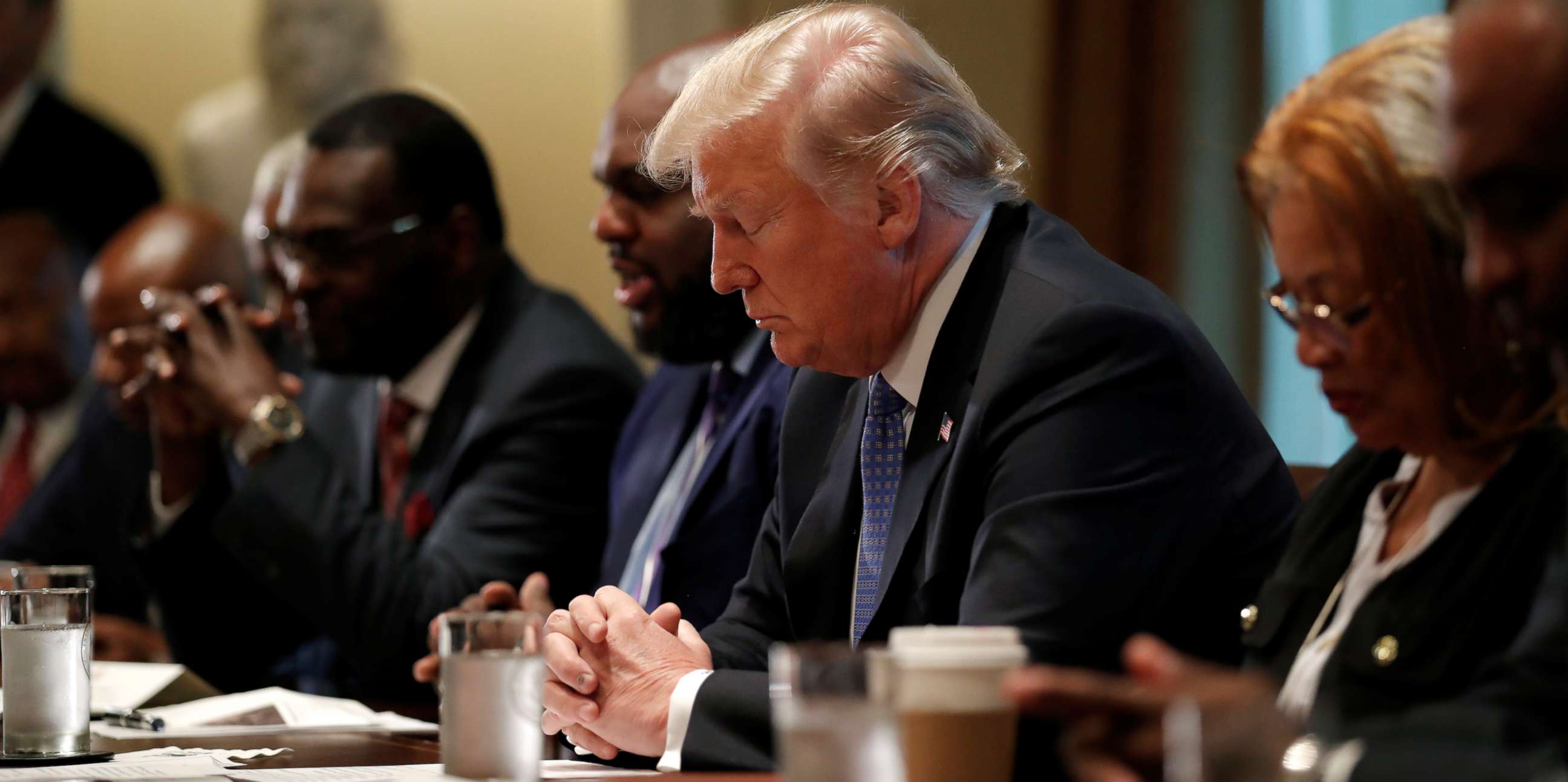 PHOTO: President Donald Trump prays during a meeting with inner city pastors at the Cabinet Room of the White House in Washington, D.C., Aug. 1, 2018.