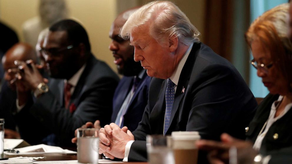 PHOTO: President Donald Trump prays during a meeting with inner city pastors at the Cabinet Room of the White House in Washington, D.C., Aug. 1, 2018.