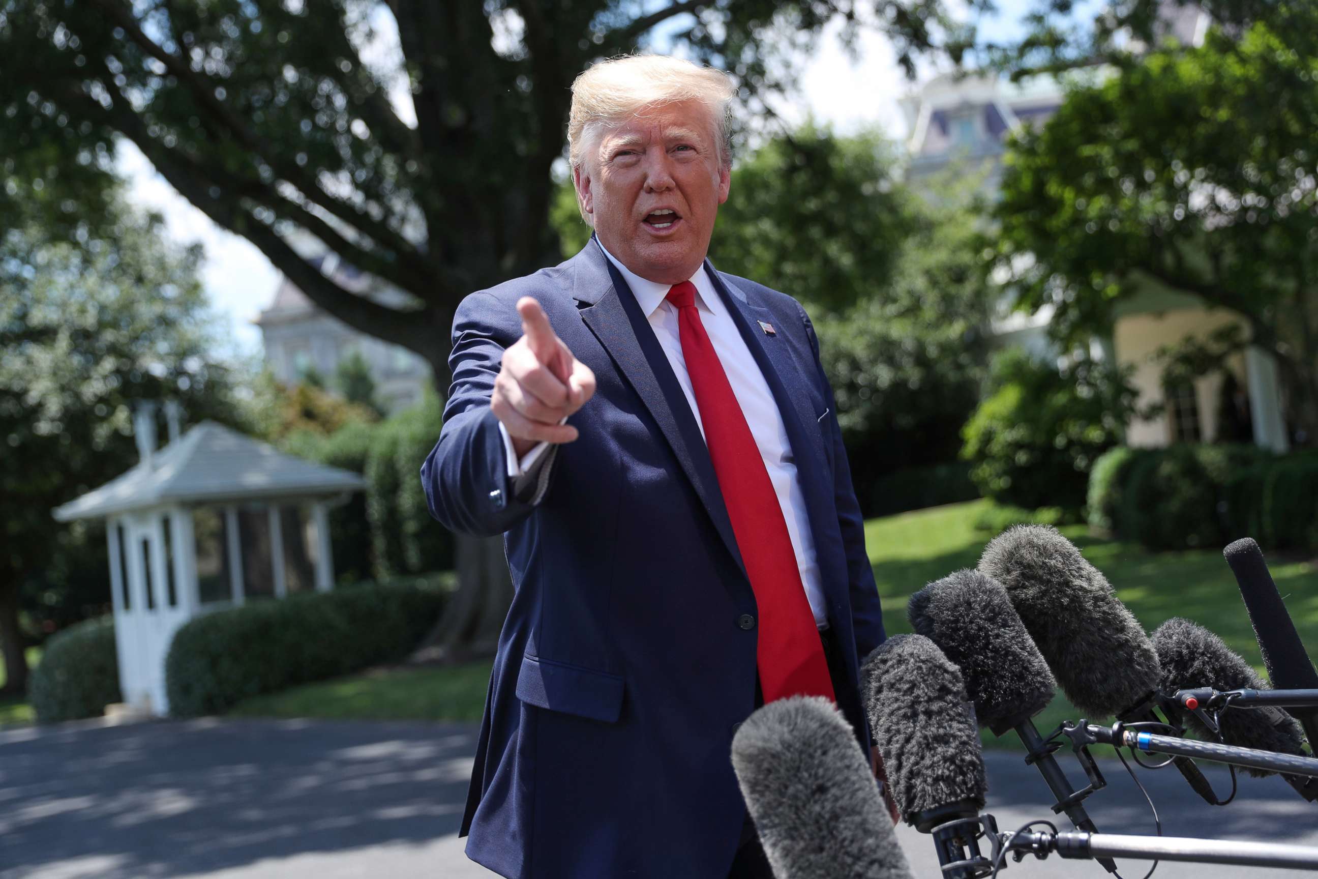 PHOTO: President Donald Trump talks to reporters as he departs for travel to the G20 Summit in Osaka, Japan outside the White House, June 26, 2019.