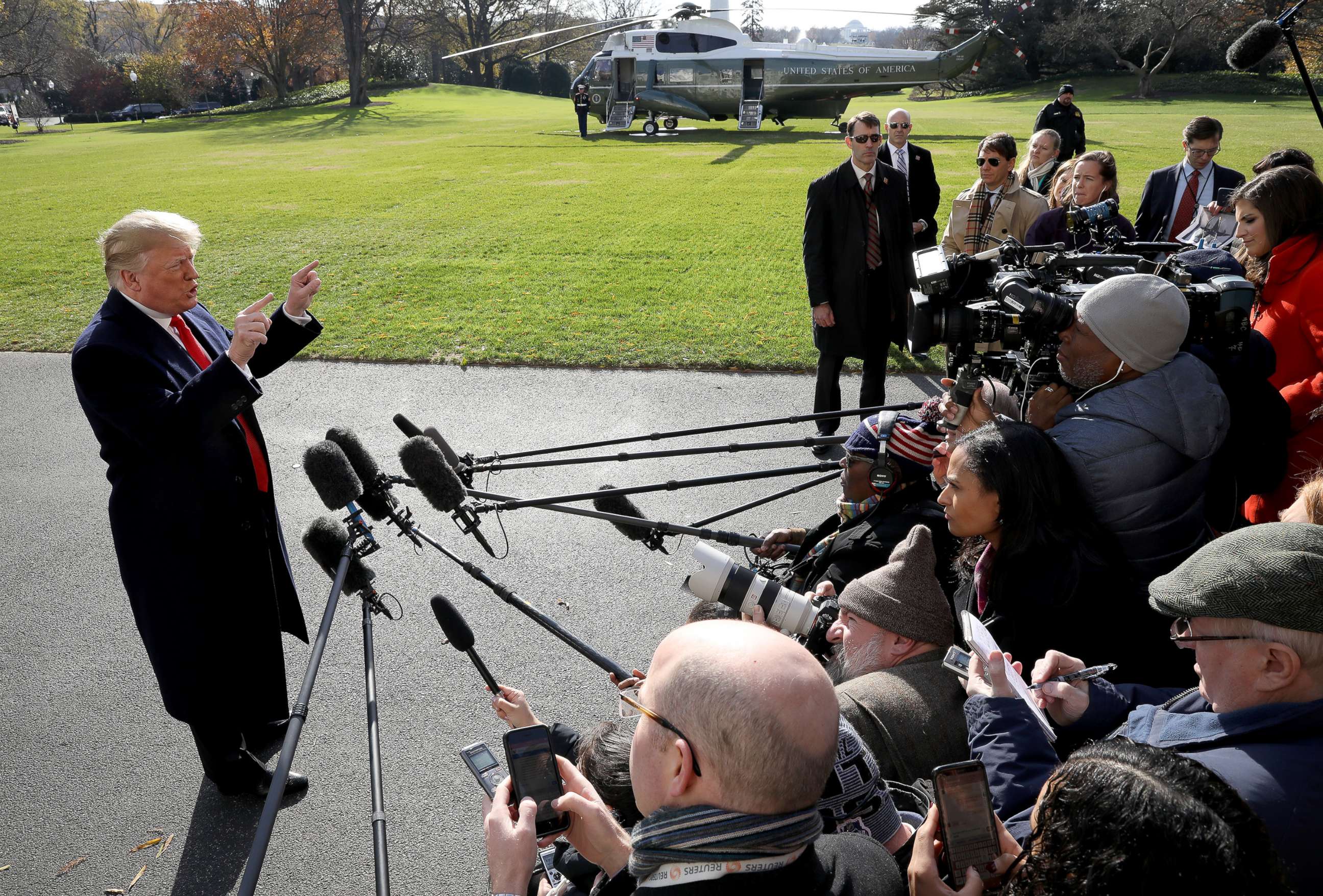 PHOTO: President Donald Trump answers questions from the press while departing the White House, Nov. 29, 2018 in Washington.